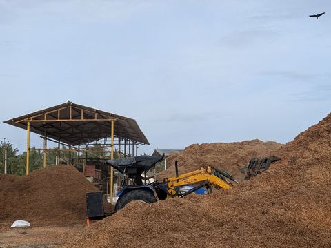 Loader working a pile of separated coir pith and fibre